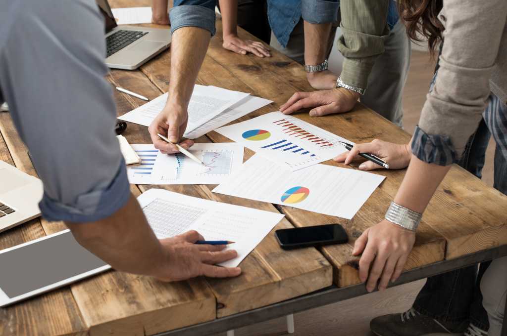 Businessman and woman discussing on stockmarket charts in office